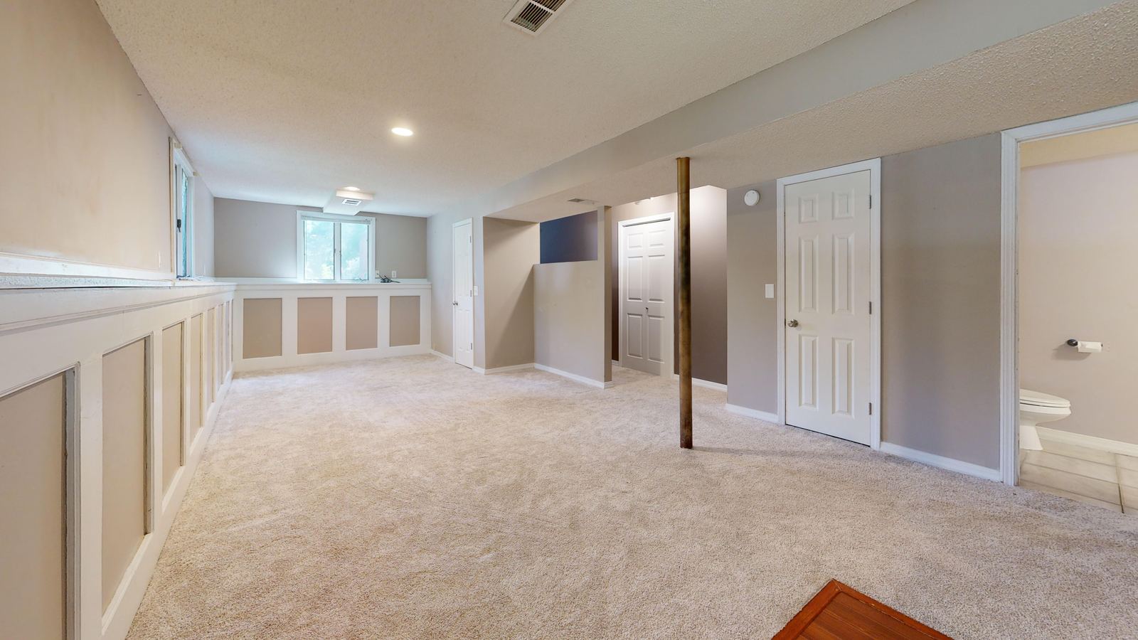 Finished basement with carpet and recessed lights