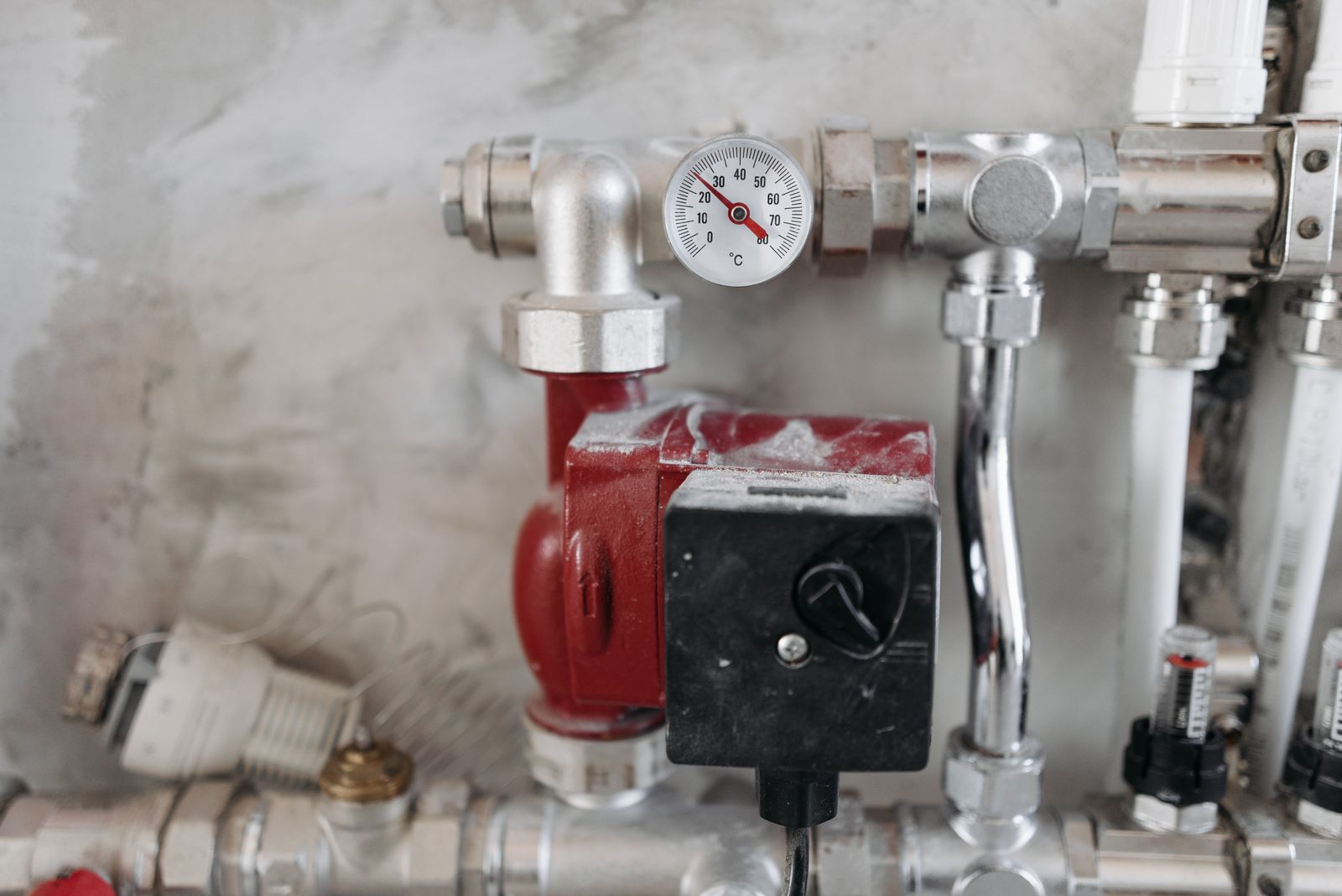 Pipes and a pressure gauge in a utility room